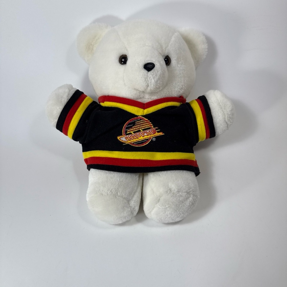 White Teddy Bear with Black red yellow 90’s Vancouver Canucks jersey. 10”